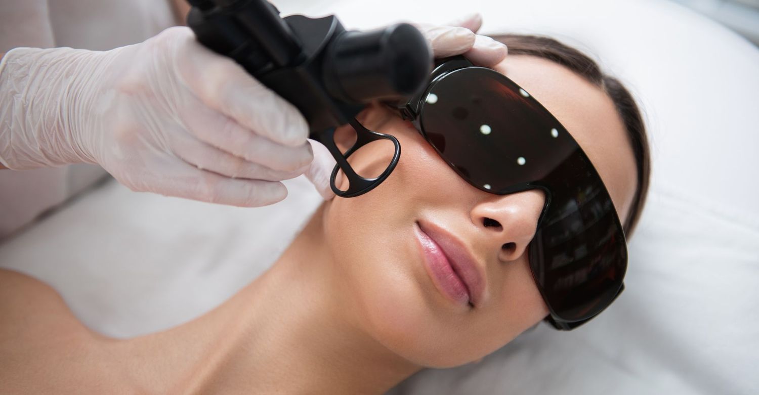 Woman receiving a facial treatment with laser.