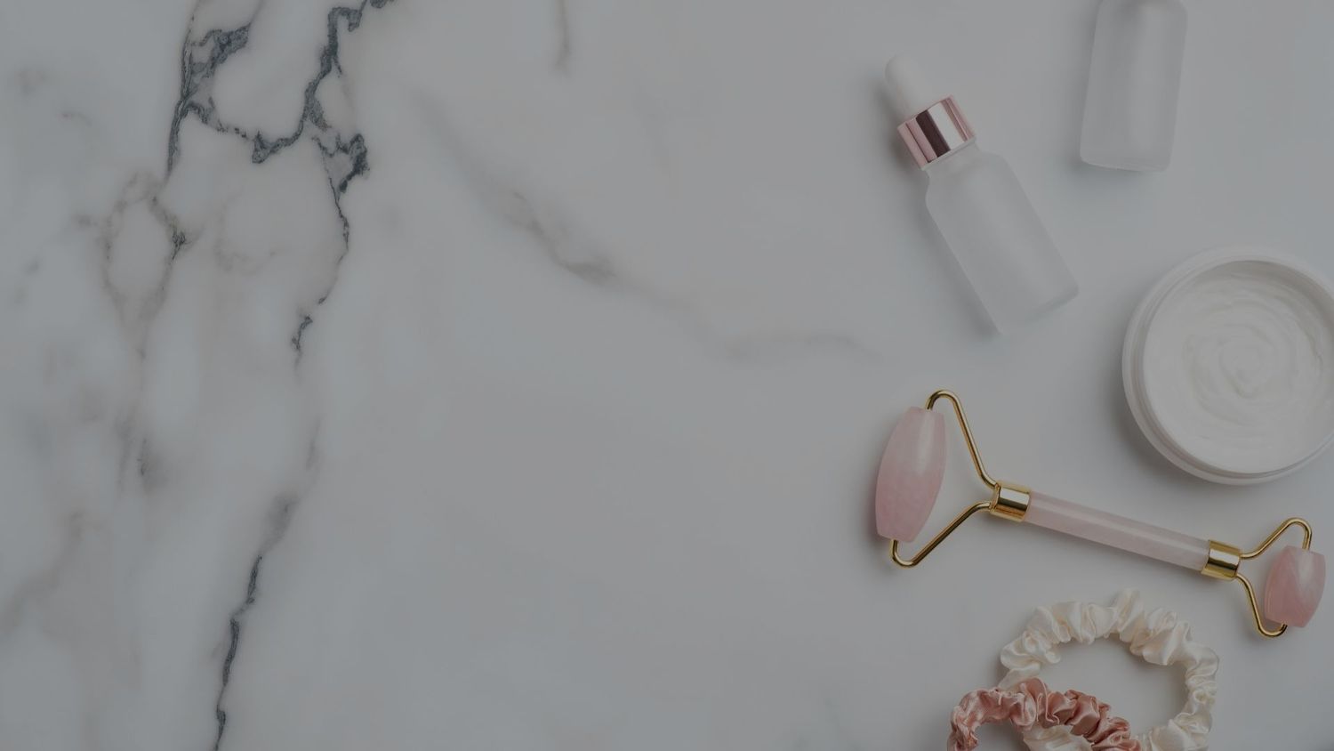 Skincare products on marble surface background
