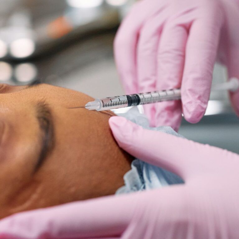 Patient receiving an injection in a clinical setting.
