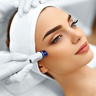 Woman receiving a facial treatment or skin procedure.