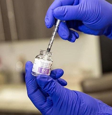 Preparing Botox injection with syringe and vial.