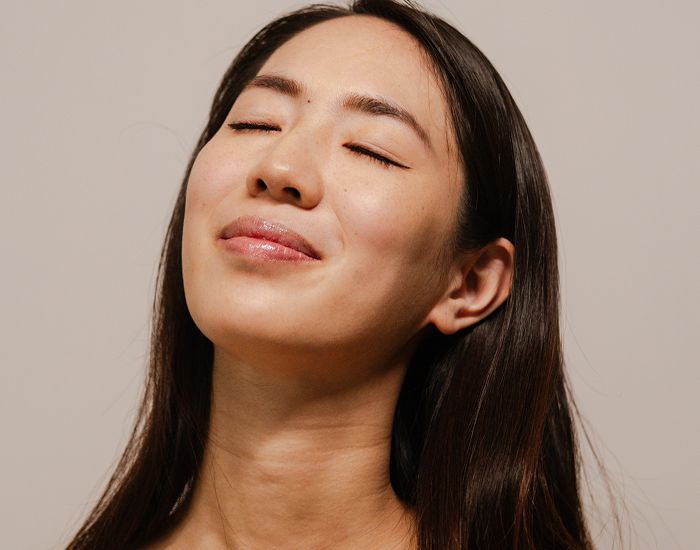 Woman with closed eyes and serene expression.
