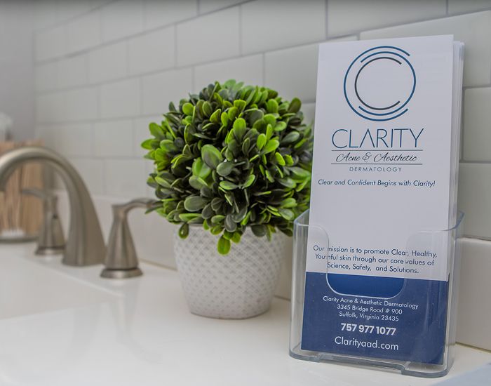 Dermatology brochure with plant on counter.