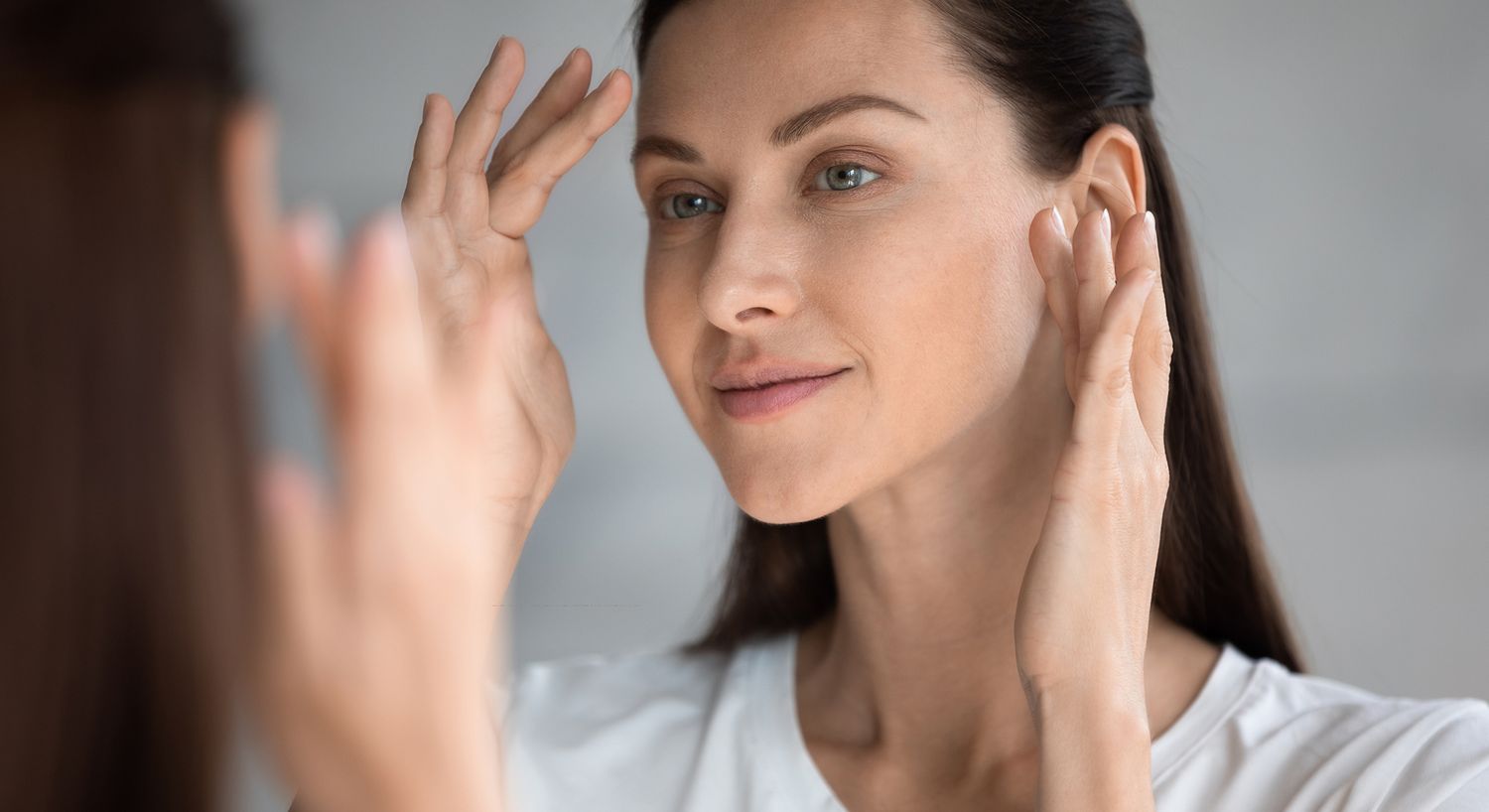 Woman with glowing skin and soft expression.
